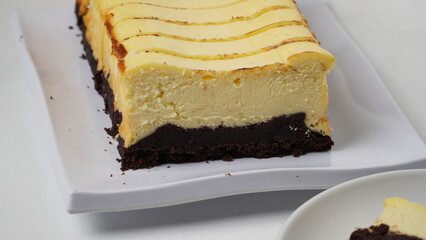 Homemade burnt cheesecake brownies isolated on white background