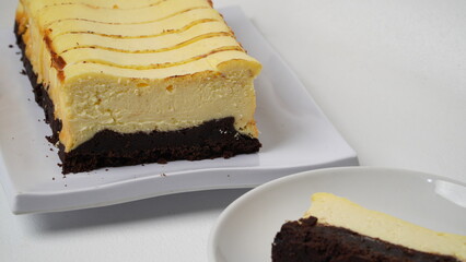 Homemade burnt cheesecake brownies isolated on white background