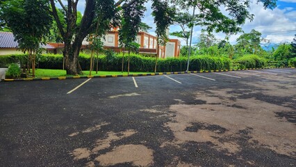 Parking lot with green trees and grass in public park, stock photo © Purwadani