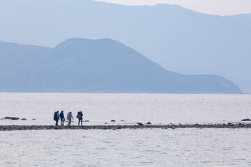 2024 Dec 26,Hong Kong ,People are seen strolling along the tombolo on Sharp Island, The tombolo is not always visible as it emerges only when low tide.