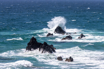 wild sea waves crashing on rocks