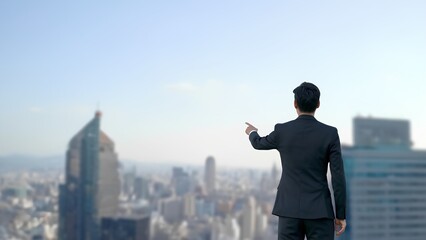 Businessman points towards city skyline urban environment professional lifestyle inspirational viewpoint aspirational concept