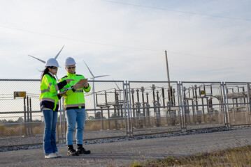 Electrician and architect work together to plan the installation and repair of wind turbines to provide sufficient backup power.