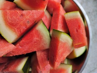 Red delicious fresh Watermelon pieces chopped and served for eating. Large edible fruit. The sweet, juicy flesh is usually deep red to pink, with many black seeds.