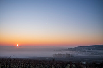 winter sunrise above the fog