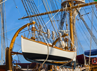 A lifeboat is securely tied to the mast of a sailing vessel
