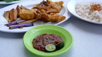 A plate of chili paste to complement the chicken menu and fried tofu with Nasi Uduk. Indonesia food.