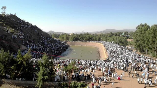 Thousands of Ethiopian people at Timkat parade- Aerial Footge 
Drone view over Large crowd parade dressed in white clothes Ethiopian Timkat Ceremony Ending, Ethiopia,19.1.2020

