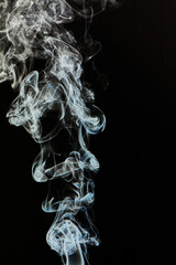 The smoke is thick and dark, creating a mood of mystery and danger