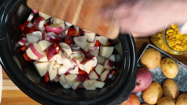 Cooking Corn Chowder for a week night meal. Preparing dinner with lots of ingredients like corn, cream, bacon, potatoes and onions.  Sizzling bacon in a skillet.