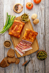 smoked lard on a board with onions and bread