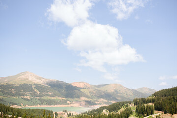 Expansive mountain range with forests under blue sky in Colorado