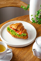 croissant with ham, tomatoes and lettuce