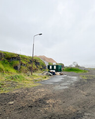 Abandoned site with a green bin