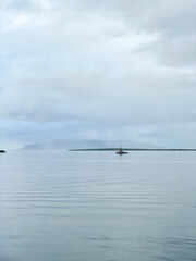 Fishing boat in tranquil waters near island