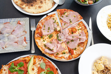 Assorted Italian cuisine dishes, pizza, pasta, salad