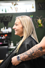 Client with sleek blonde hair smiling after a salon session, sty
