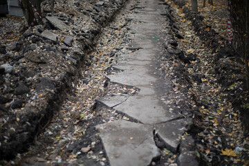 Broken asphalt in the city. The old way.