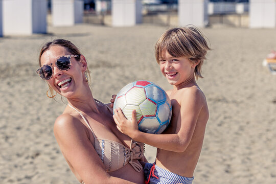 Mother and son laughing while looking at the camera