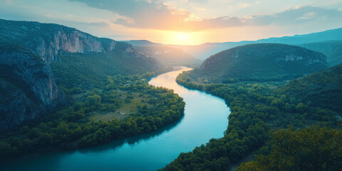 Fototapeta premium Winding river cutting through a canyon, surrounded by cliffs and forests