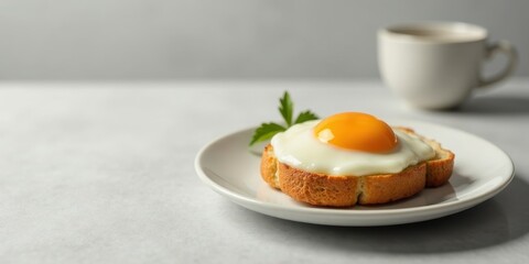 A Sunny-Side Up Egg on Toast with a Garnish, Served on a Plate Next to a Cup