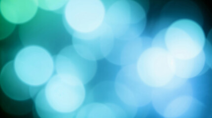 Abstract blurred turquoise and green bokeh lights background creating festive atmosphere