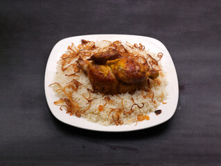 Shawai chicken Peshawar rice in a white ceramic plate in a dark background