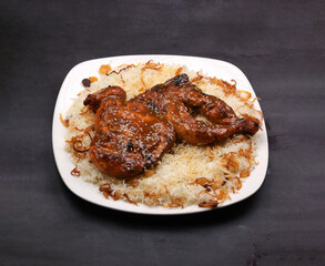 Honey glazed fried chicken Peshawar rice in a white ceramic plate in a dark background