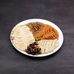 Mixed Hummus large platter plate with olive oil, mutabel, tahini, tzaziki and babaganosh