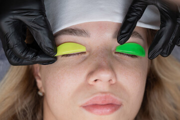 Caucasian woman undergoing eyelash lamination procedure. 