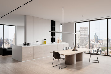 Modern kitchen interior with wooden cabinets and dining area in a bright room with large windows...