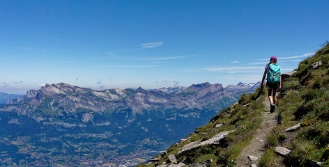 Teenage girl hiking in summer in the Mont blanc area, view over the valley of Sallanches and the Fiz Mountain