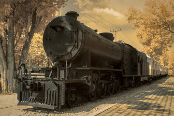 Infrered photography, a vintage steam locomotive, prominently displayed at a park