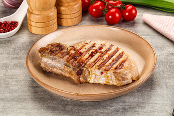Grilled pork loin steak with bone