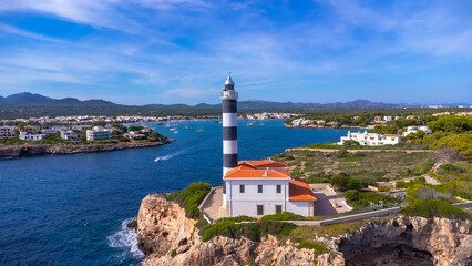 Portocolom lighthouse guiding ships in beautiful mallorca, spain