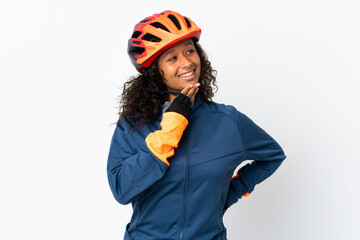 Teenager cyclist woman isolated on white background looking up while smiling