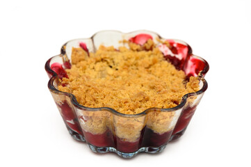 Delicious berry crumble dessert in a vibrant glass dish ready to be served at a summer gathering