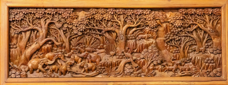 Intricate wood relief carving at the monastery located at the temple of Wat Paknam Phasi Charoen in Bangkok, Thailand.
