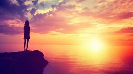 Fototapeta premium Person at Cliff Enjoying Ocean View at Sunset