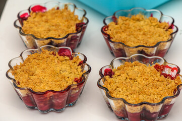 Delightful berry crumble served in glass dishes, perfect for dessert lovers at a summer gathering