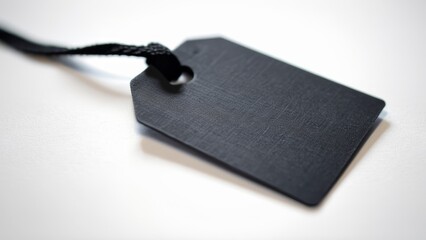 black product tag with text on white background