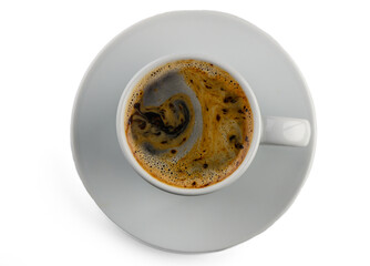 Delightful swirling patterns in a steaming cup of coffee served on a white saucer