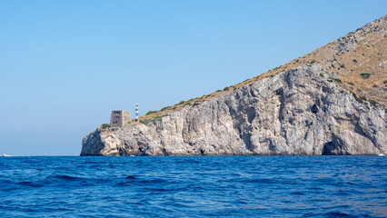 Punta Campanella with its ancient Saracen Tower viewed from the sea. A breathtaking perspective of the Amalfi Coast, Italy, perfect for travel and historical projects.