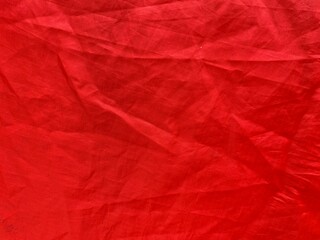 close up of a red fabric, tent fabric as textured background 