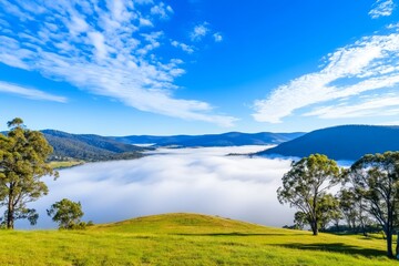 Fototapeta premium Serene Valley Mist - Tranquil landscape, misty valley, vibrant sky, green hills, sunrise serenity.