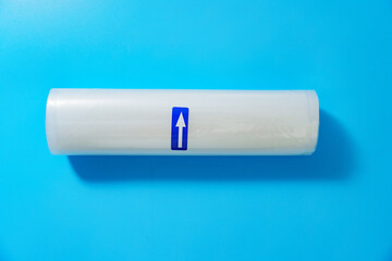Roll film for a product vacuum sealer machine on a blue background. long-term storage of products at home.