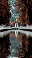 Fototapeta premium Serene Autumn Canal with Bridge and Trees Reflection