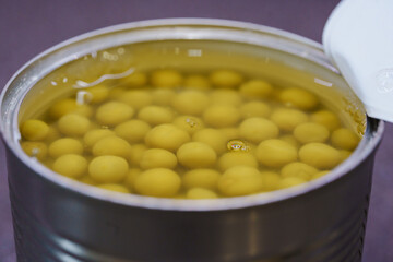 Close-up of canned green peas in a can. ingredient for cooking.