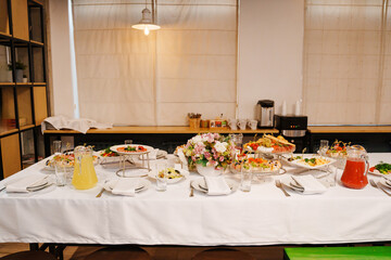 A served festive table with a variety of snacks and drinks. catering for a holiday.