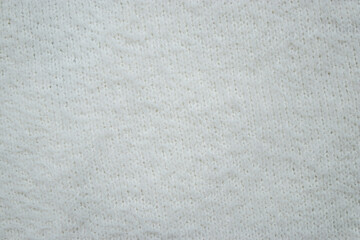 Close up of knitted white fabric, abstract textured background 